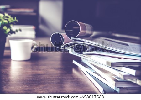 selective focus of the stacking magazine place on table in living room Royalty-Free Stock Photo #658017568
