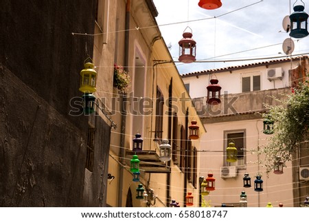 Colored lamps hanging from houses in city