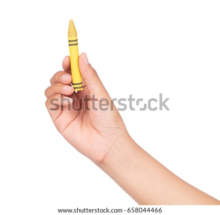 hand holding yellow crayon isolated on white background