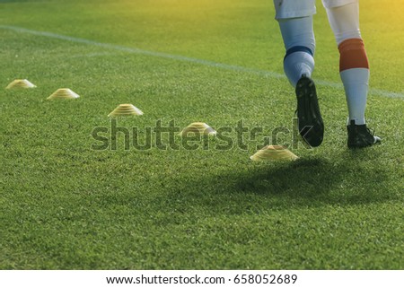 funnels on on soccer field. Soccer player practice before game start