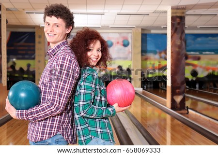 Couple having fun in bowling club