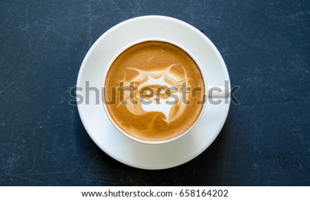 Coffee made with picture of raccoon wearing mask in froth