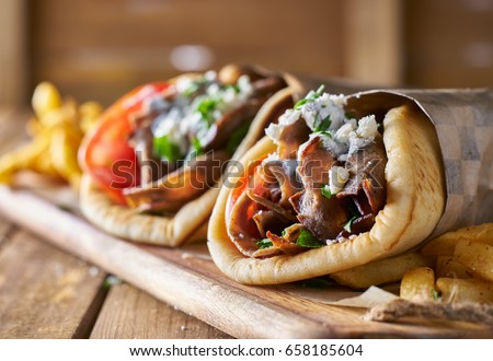 two tasty wrapped greek lamb gyros Royalty-Free Stock Photo #658185604