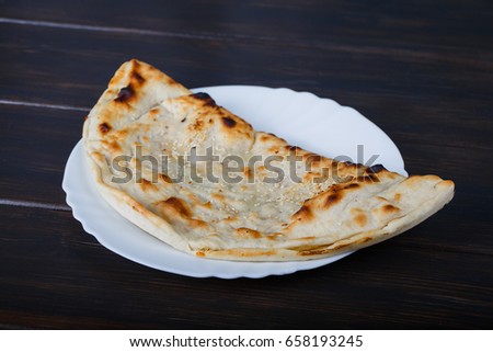 
Closed pizza on a wooden board