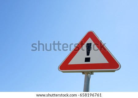 Caution sign with clearly sky on the background