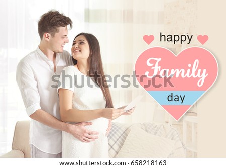 Man with pregnant wife and ultrasound image at home. Happy family day concept