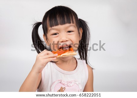 Little girl eating pizza on white background.