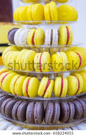 Yellow, white and brown cake macrons on stand for kids birthday party
