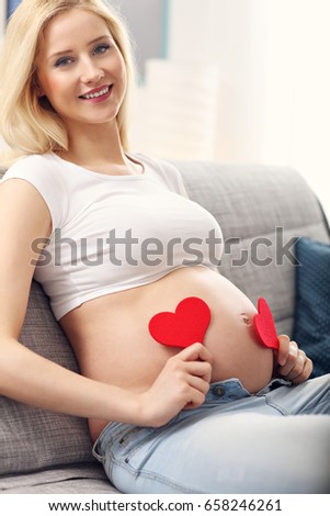 Picture of happy pregnant woman resting on sofa