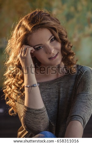 Beautiful redhead girl with curly hair