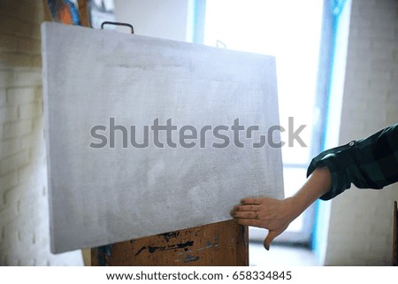 The artist paints a portrait of oil on canvas
