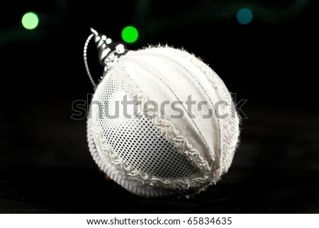 White christmas ball and colorful lights on the black background