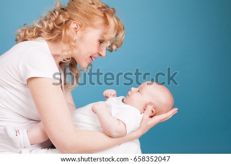 mom looks lovingly at baby son keeps on hand