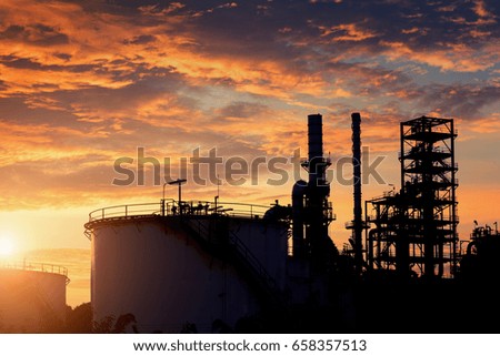 silhouette of crude oil refinery during sunset