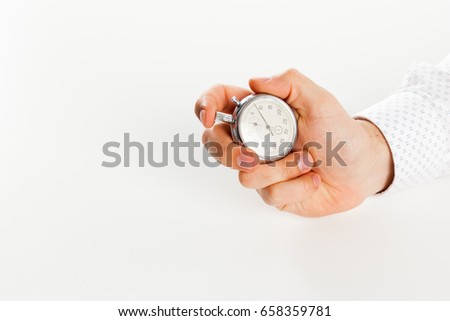 Close up of hand holding stopwatch, isolated on white background