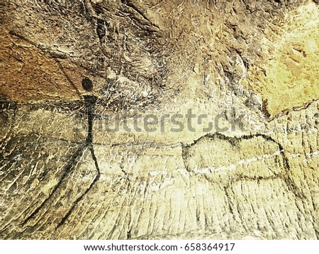 Buffalo hunting. Paint of human hunting on sandstone wall, prehistoric picture. Black carbon abstract children art in sandstone cave. Spotlight shines on prehistorical human painting.