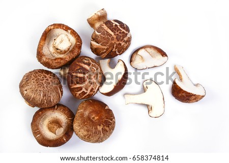 Fresh Shiitake mushroom Cut into pieces isolated on white background. Royalty-Free Stock Photo #658374814