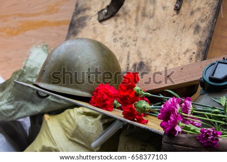 Old rusty army helmet. The eternal flame in honor of Ukranian re