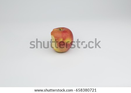 The apple is bitten away on a white background.