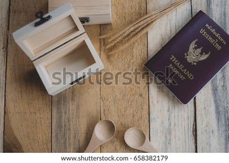 A wooden box passport, placed on a wooden floor.