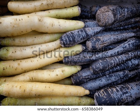Blue and white carrots on a farmers market