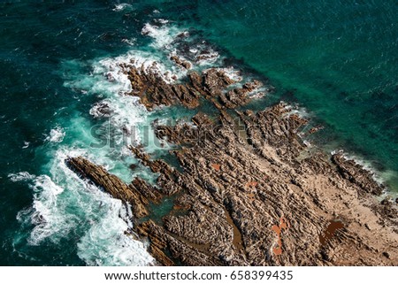 Aerial view of Geyser Rock, a small island next to Dyer Island which is home to a colony of Cape fur seals, off the coast of Gansbaai, South Africa
