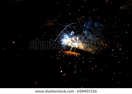 Sparks from welding on a dark background.