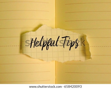 A piece of paper written ' Helpful Tips ' on paper background.
