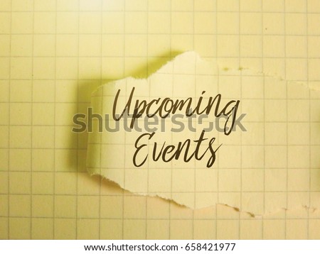 A piece of paper written ' Upcoming Events' on a book.