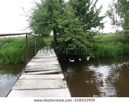 The old bridge through small river in rural areas.
