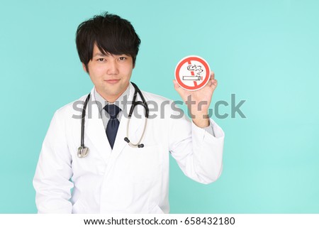 Doctor holds non smoking sign