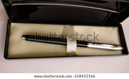 closeup crop stylish black and silver pen with stylish box in white background