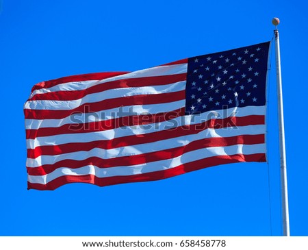 american flag waving in blue sky