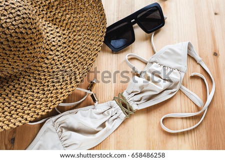 Summer accessories. Straw hat with sunglasses with swimsuit 
