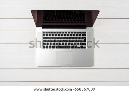 Overhead shot of modern laptop on white wooden table
