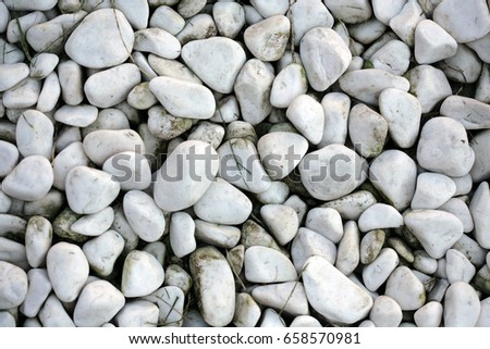 White small stones background; top view, selective focus.