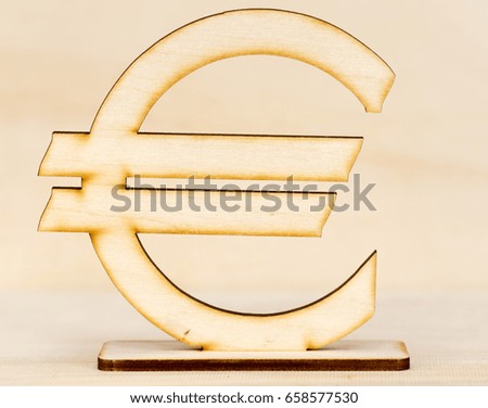 Wooden euro sign on the background of a wooden board