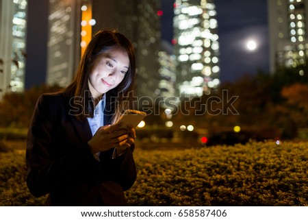 Business woman working on mobile phone at Tokyo city