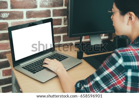 back view of beauty confident woman photographer using mobile laptop computer transport business picture with camera ready to editing retouch on working desk.