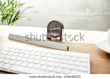 table watch with keyboard, ruler on the wood desk.