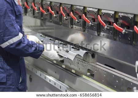 The technician operator use hydraulic bending machine. Metal working concept