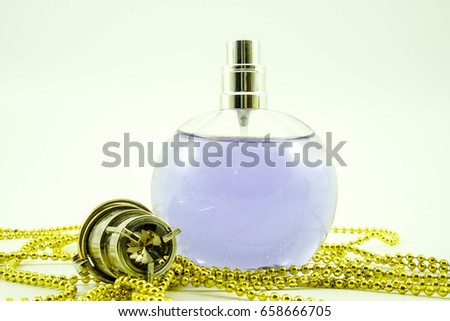 Perfume bottles with white rose flowers on light background. fragrance cosmetics, fragrance collection. Free space for text. Purple and gold concept