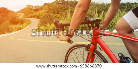 Asian men are cycling road bike in the morning.downhill