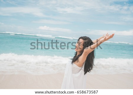 Travel and Vacation. Freedom Concept. excited woman on The Beach enjoying summer under the blue sky
