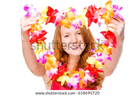 Floral lei in focus in hands of happy girl close-up