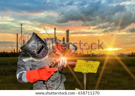 worker welding steel by tig pipe,double exposure concept factory and Oil refinery sunset background