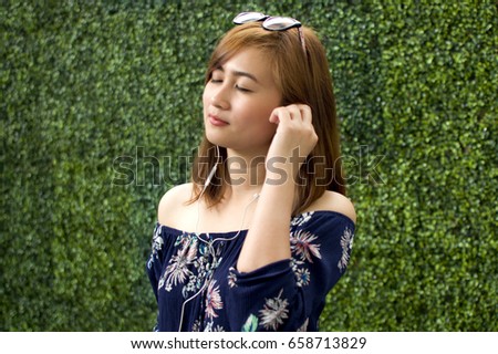 A woman is listening to a music