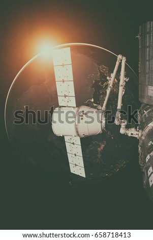 SpaceX Dragon orbiting the planet Earth. Elements of this image furnished by NASA.