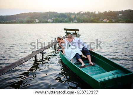 young couple in love sitting in a small boat and having fun.