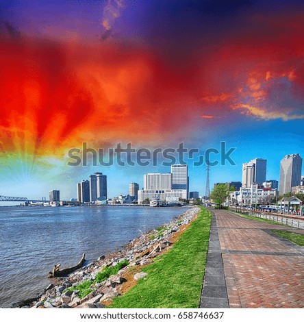New Orleans, Lousiana. Mississippi waterfront with walkway and city buildings.